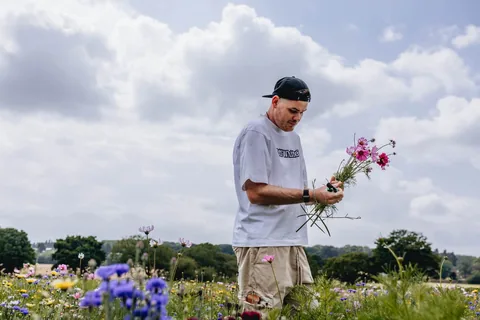 Sam outdoors among flowers